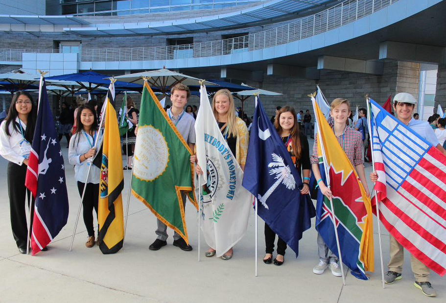 Students holding flags at the Sister Cities International Annual Conference Opening Ceremony